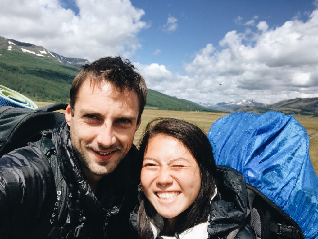 Phil and Anya smiling after the rain during their Altai Mountains trek
